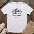 White dog lover t-shirt with Dogs Judge Less Love More slogan in pink botanical paw print design by Fetchkind