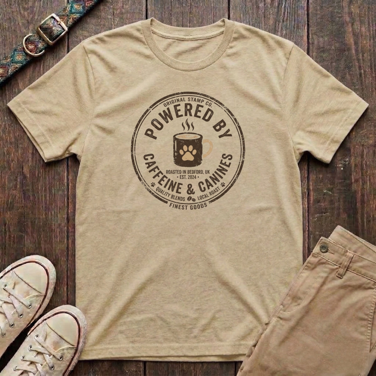 Natural dog lover t-shirt with Powered by Caffeine and Canines distressed stamp badge and coffee paw print design by Fetchkind